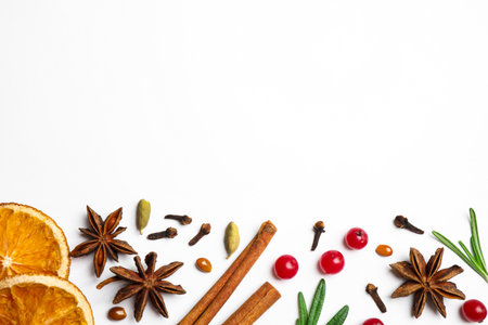 Different mulled wine ingredients on white background, flat lay. Space for textの写真素材