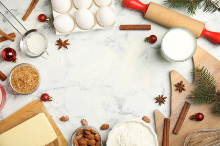 Flat lay composition with ingredients for traditional Christmas cake on white marble table. Space for textの写真素材