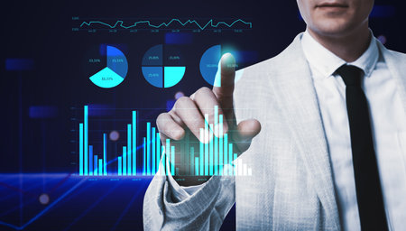 business analytics. Man and virtual screen with graphs on color background, closeup