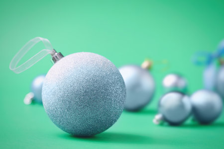Many beautiful Christmas balls on green background. Space for textの写真素材