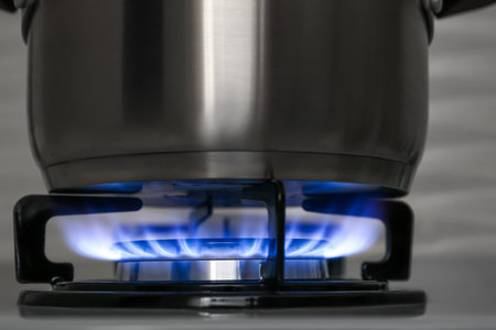 Pot on modern gas cooktop in kitchen, closeupの写真素材