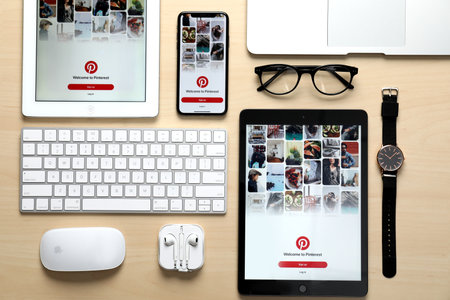 MYKOLAIV, UKRAINE - AUGUST 27, 2020: Flat lay composition with iPhone 11 and iPad tablets on wooden tableのeditorial素材