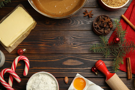 Flat lay composition with ingredients for traditional Christmas cake on wooden table. Space for textの写真素材