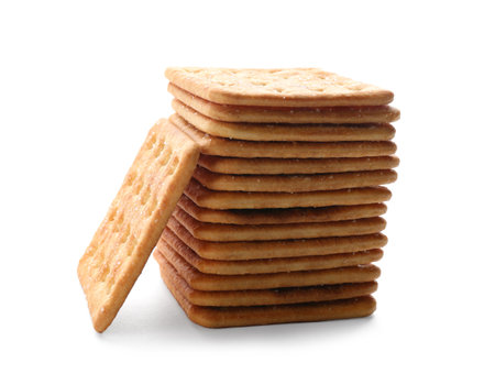 Stack of delicious crispy crackers isolated on whiteの写真素材