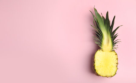 Half of pineapple on pink background, top view. Space for textの写真素材