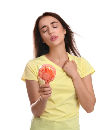 Woman with portable fan suffering from heat on white background. summer seasonの写真素材