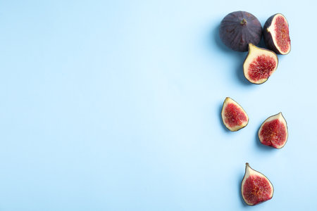 Delicious ripe figs on light blue background, flat lay. Space for textの写真素材
