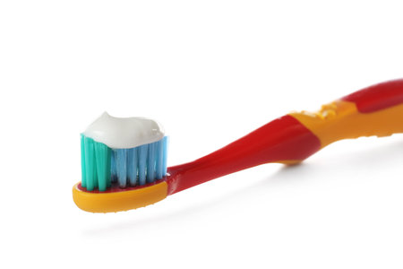 Toothbrush for children with paste isolated on white, closeup. dental careの写真素材