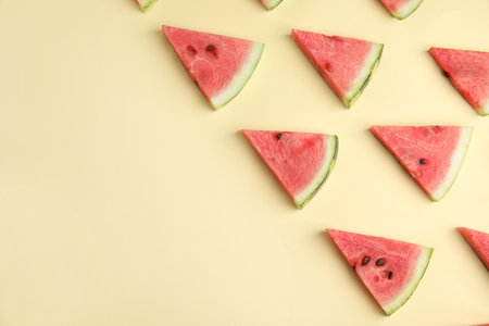 Slices of ripe watermelon on beige background, flat lay. Space for text