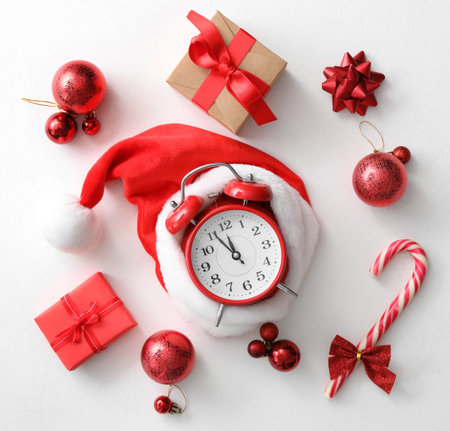 Flat lay composition with alarm clock and Christmas decor on white background. New Year countdownの写真素材