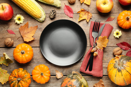 Flat lay composition with tableware, autumn fruits and vegetables on wooden background. Thanksgiving Dayの写真素材