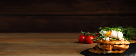 Delicious sandwich with arugula and egg on wooden table, space for text. banner designの写真素材