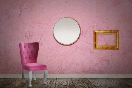Chair near wall with mirror, wooden frame and patterned wallpaper. Stylish room interiorの写真素材