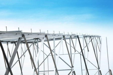 High voltage tower construction outdoors. Installation of electrical substation