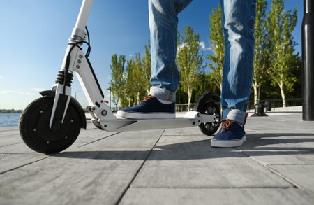 Man with kick scooter on city street, closeup
