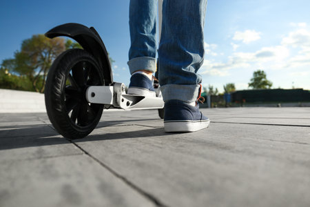 Man with kick scooter on city street, closeup