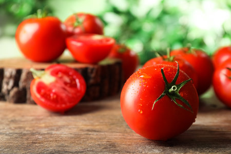 Fresh ripe tomatoes on wooden table, closeupの写真素材