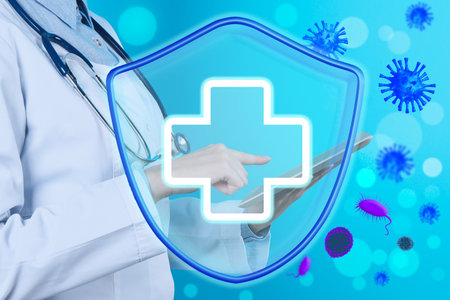 Immunologist and shield with cross as symbol of virus protection on light blue background, closeupの写真素材