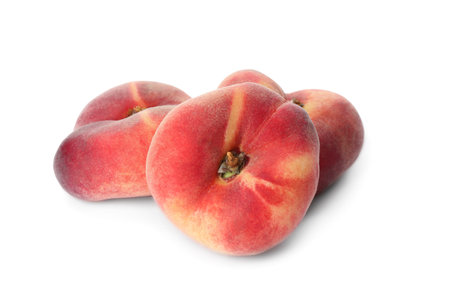 Fresh ripe donut peaches on white backgroundの写真素材