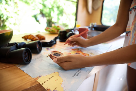 Young traveler with world map planning trip in motorhome, closeupの写真素材