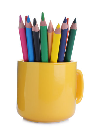Colorful pencils in yellow cup on white backgroundの写真素材