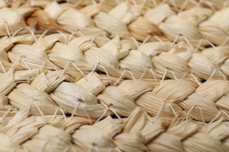 Elegant woman's straw bag as background, closeup