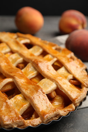 Delicious fresh peach pie on gray table, closeupの写真素材