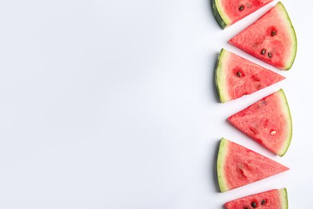 Slices of ripe watermelon on white background, flat lay. Space for textの写真素材