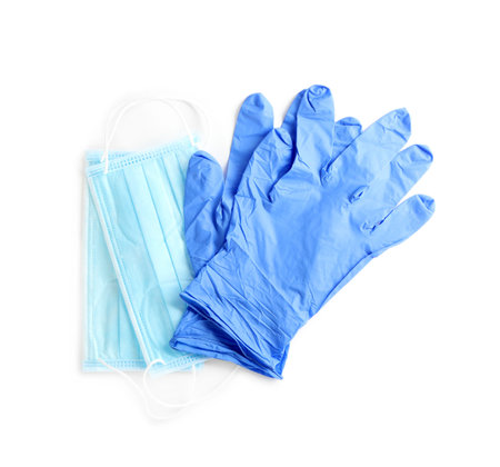Medical gloves and protective face masks on white background, top viewの写真素材