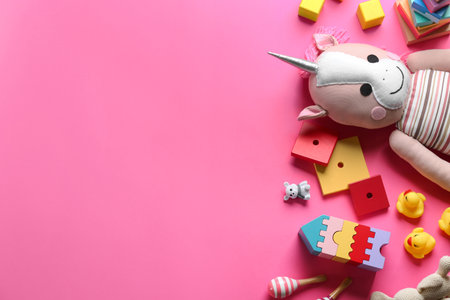 Flat lay composition with different toys on pink background. Space for textの写真素材