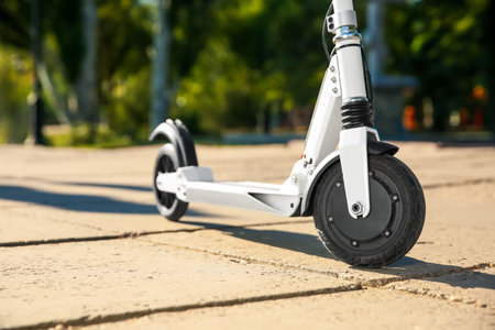 Modern electric kick scooter outdoors on sunny day, closeupの写真素材