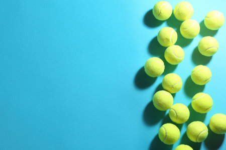 Tennis balls on blue background, flat lay. Space for textの写真素材