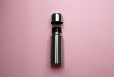 Stainless steel flask on pink background, top viewの写真素材