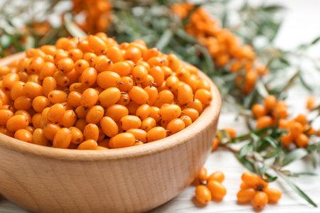 Fresh ripe sea buckthorn in wooden bowl, closeupの写真素材