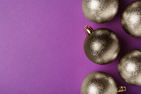 Many shiny Christmas balls on purple background, flat lay with space for textの写真素材