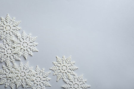 Beautiful snowflakes on white background, flat lay. Space for text