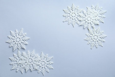 Beautiful snowflakes on white background, flat lay. Space for textの写真素材