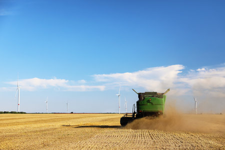 Modern combine harvester working in agricultural fieldの写真素材
