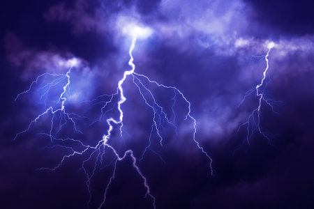 Lightnings in dark cloudy sky during thunderstorm