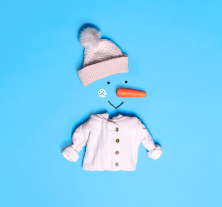 Creative snowman shape made of different items on light blue background, flat layの写真素材