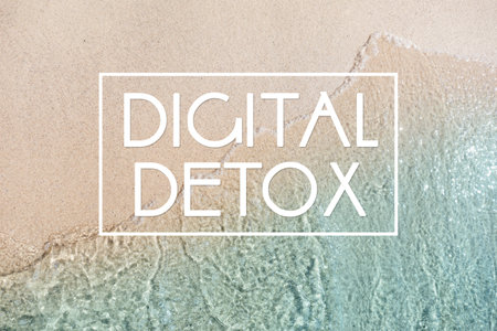 Text Digital Detox and top view of ocean waves rolling on sandy beach as backgroundの写真素材