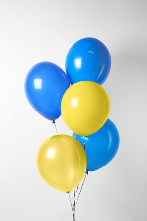 Many balloons in colors of Ukrainian flag on light backgroundの写真素材