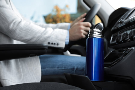 Blue thermos in holder inside of carの写真素材