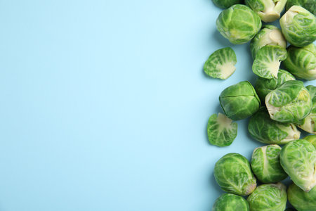 Fresh Brussels sprouts on light blue background, flat lay. Space for textの写真素材