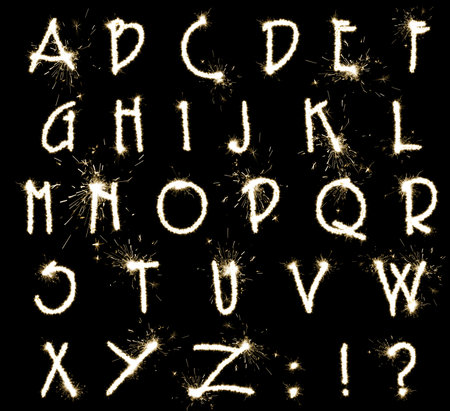Set with letters made of sparkler on black backgroundの写真素材