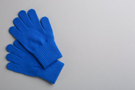 Pair of stylish woolen gloves on light grey background, flat lay. Space for textの写真素材