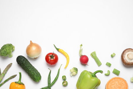 Flat lay composition with fresh vegetables on white background. Space for textの写真素材