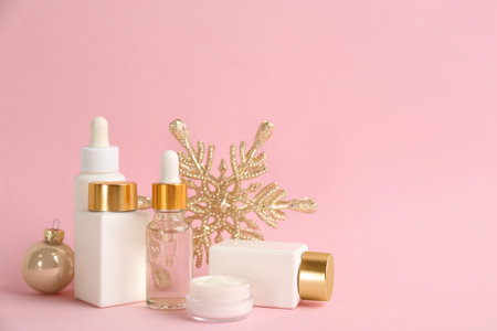 Beautiful composition with cosmetic products on pink background, space for text. Winter careの写真素材