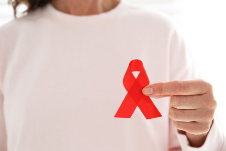 Woman holding red awareness ribbon, closeup with space for text. World AIDS disease dayの写真素材
