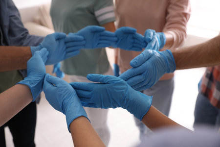 People in blue medical gloves showing circle with hands on light background, closeupの写真素材